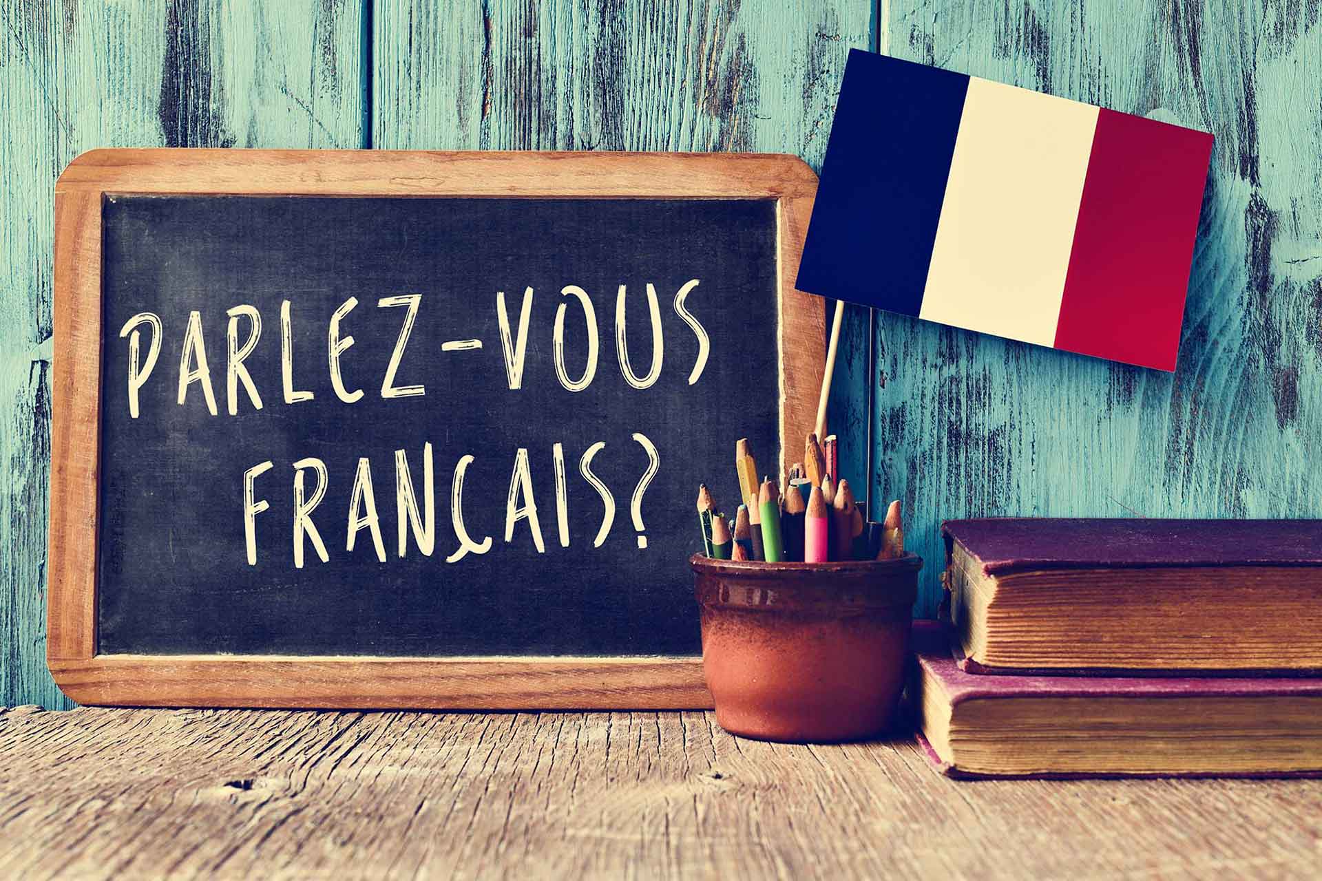 Tableau avec les mots "Parlez-vous français" écrit en craie
